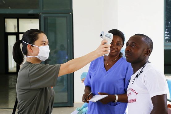 George Gao with Tim Brooks, head of Public Health England’s rare and imported pathogens lab, who recently deployed to Sierra Leone. COURTESY OF GEORGE GAO