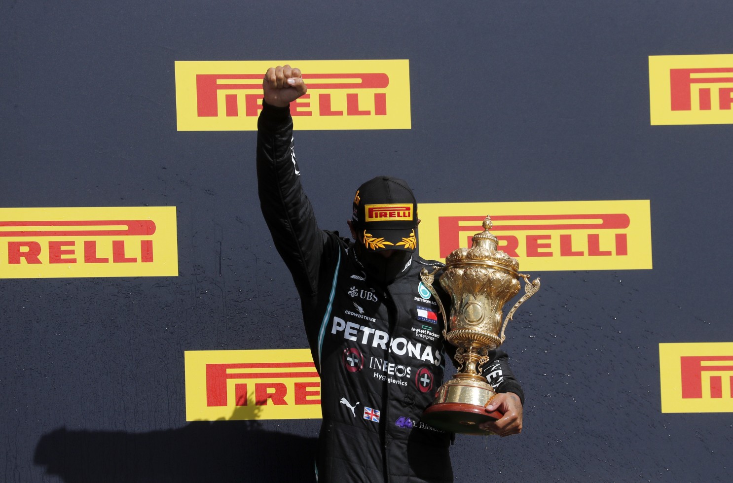 Hamilton limps to record British GP win after late puncture